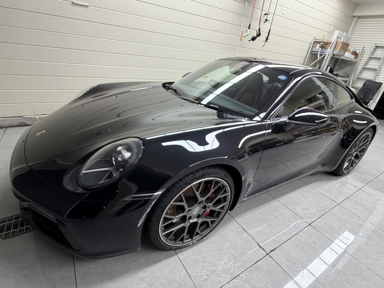 Front-quarter view of a black Porsche 911 (992.1) after clear PPF installation at EISUI WRAP