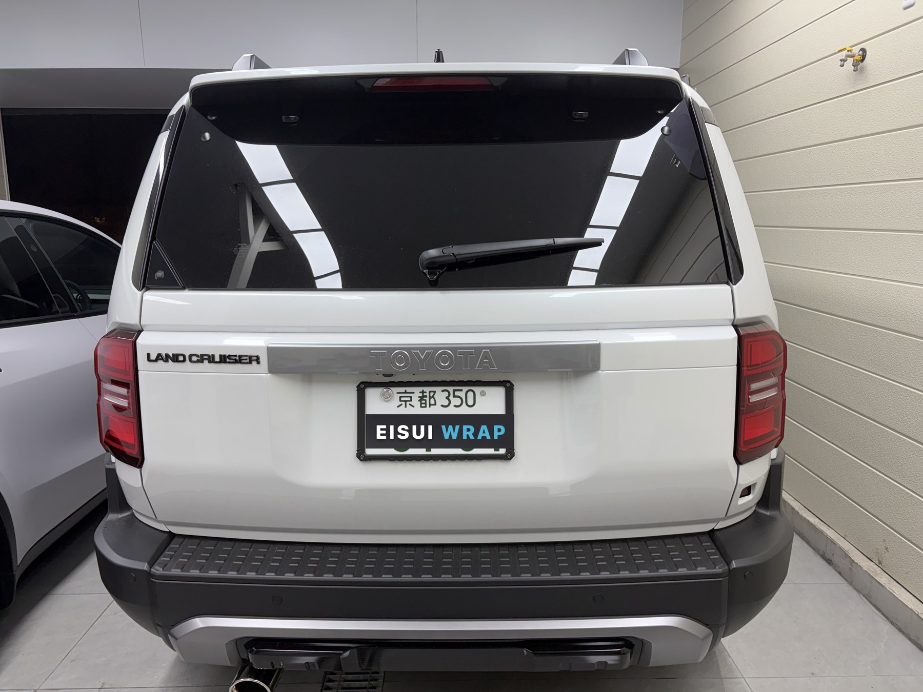 2026 Land Cruiser 250 glossy white paint before clear matte PPF, rear view