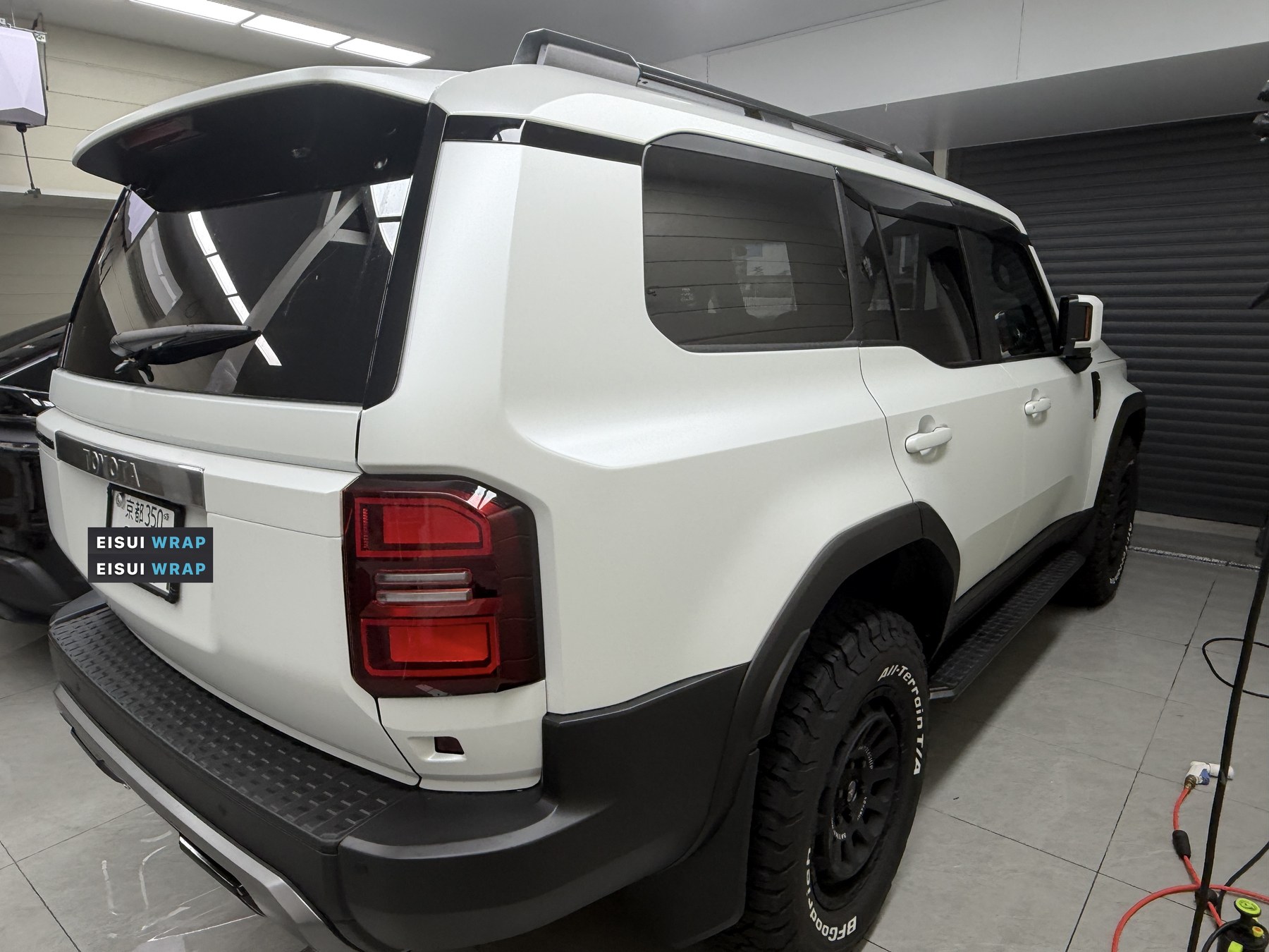 Matte white Land Cruiser 250 seen from the rear quarter after installation