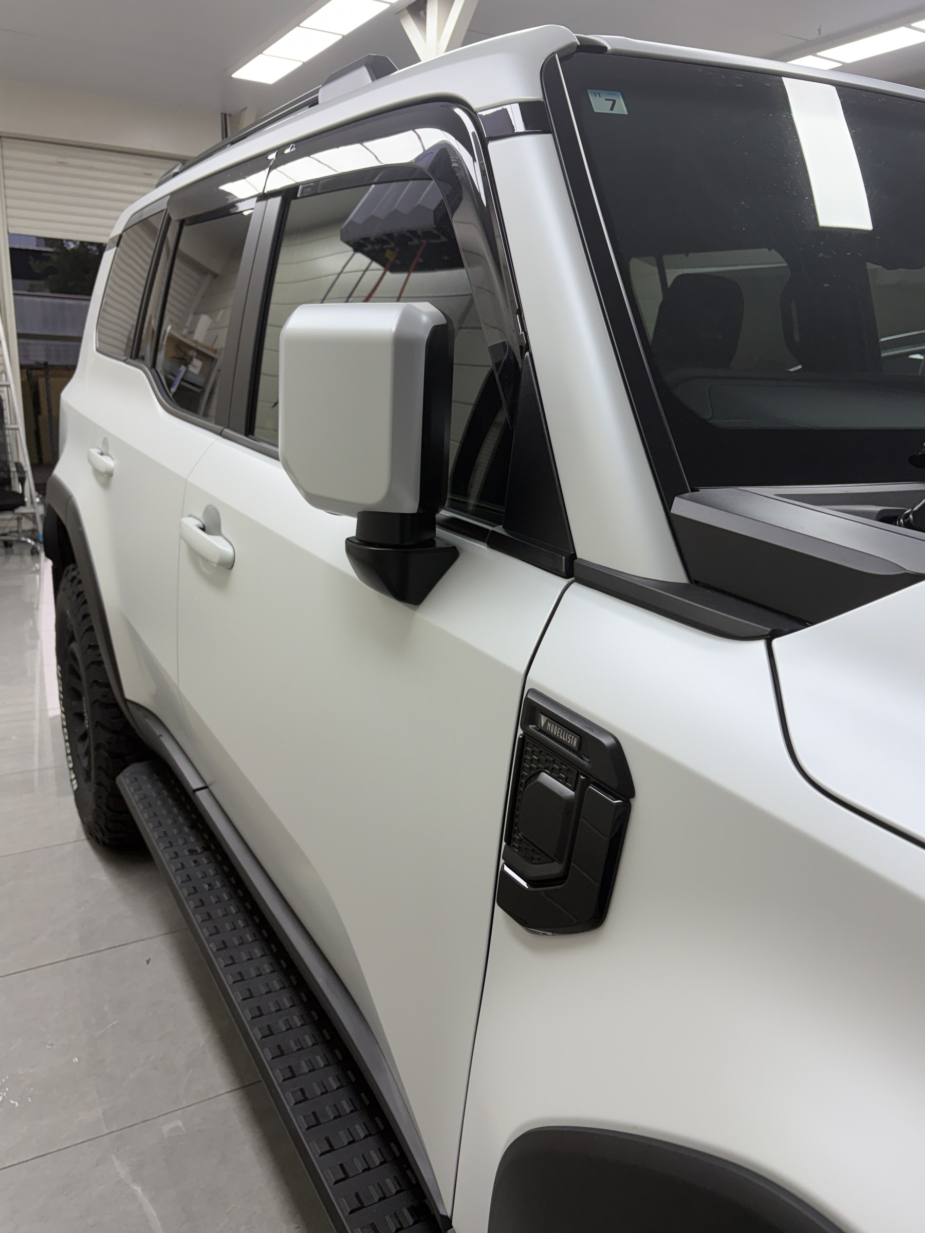 White door mirror and door after clear matte PPF on the Land Cruiser 250