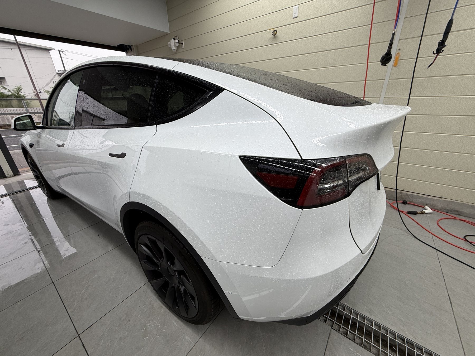2024 Tesla Model Y pearl white before color PPF, rear quarter
