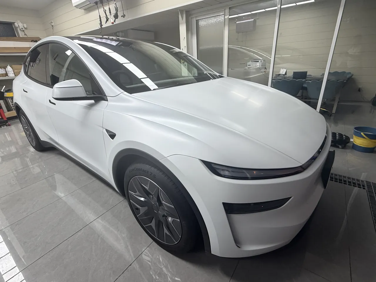 White 2026 Tesla Model Y L after satin clear PPF and matte black window trim installation
