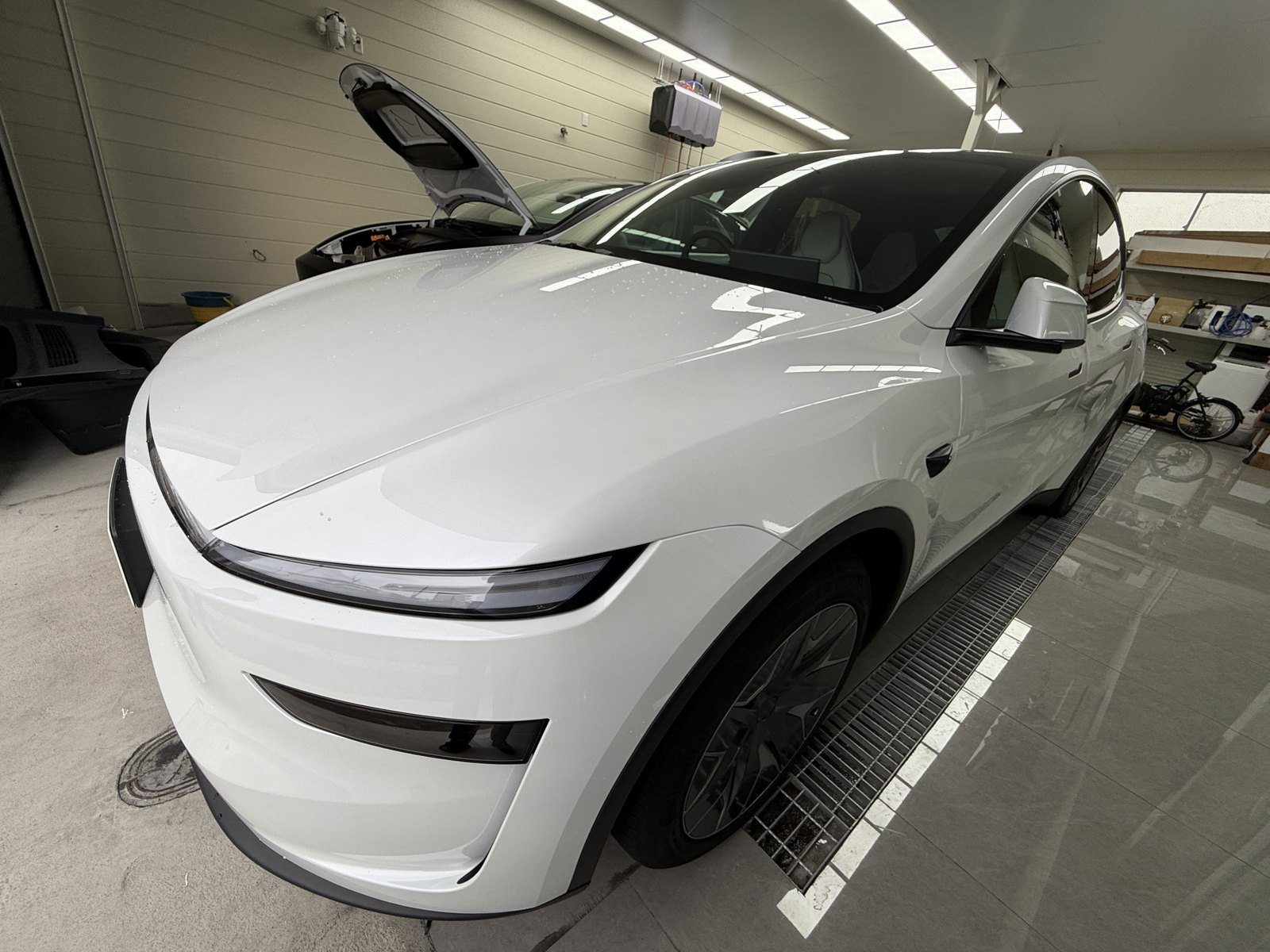 White 2026 Tesla Model Y L before satin clear PPF, front quarter