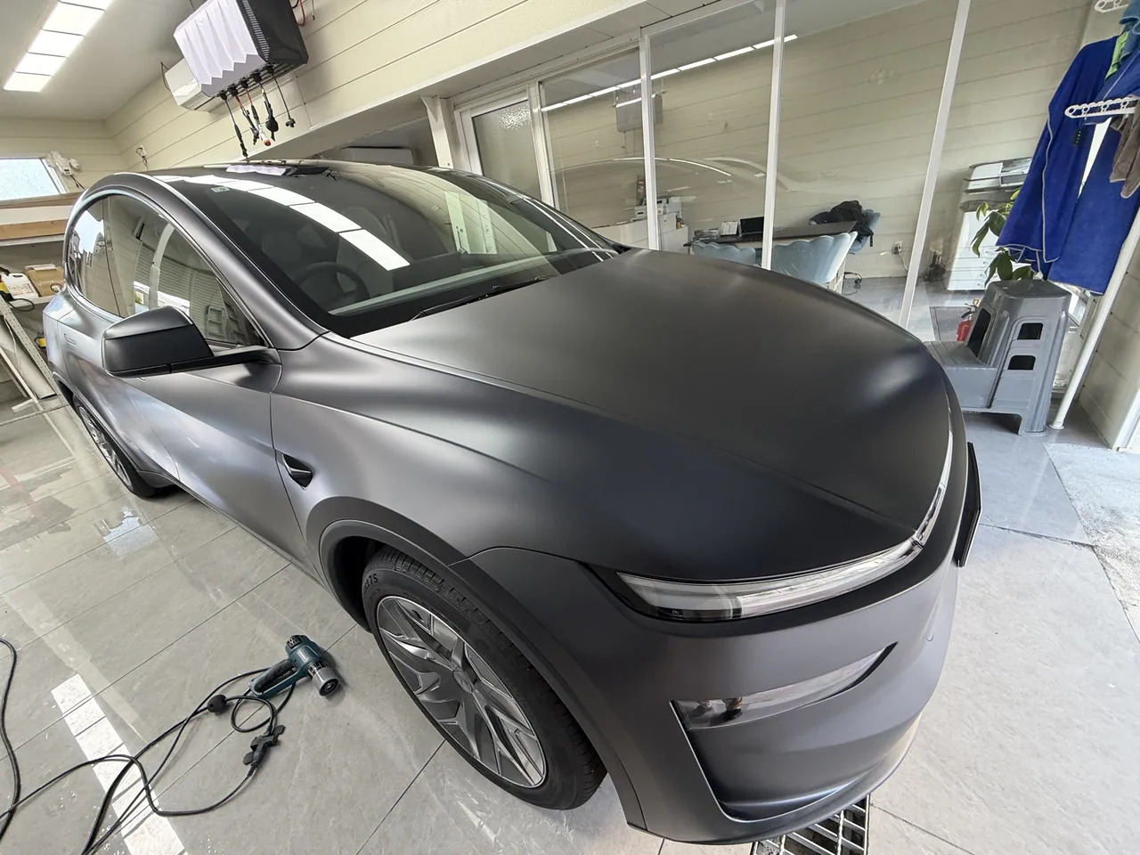 Kyoto customer's 2026 Tesla Model Y L in Stealth Grey, front-quarter view after EISUI matte clear PPF installation in Suminoe-ku, Osaka
